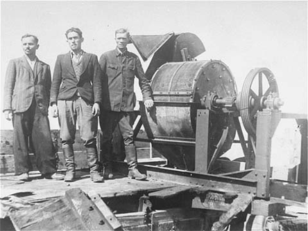 HOLOCAUST: Members of a Sonderkommando 1005 unit pose next to a bone-crushing machine in the Janowska concentration camp in Poland. (Jun 1943  Oct 1943)
