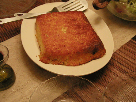 Tah-chin, a savory saffron rice-cake with a filling, commonly marinated chicken fillets